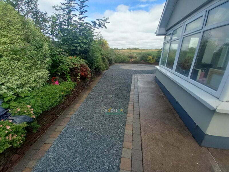 In this project we have replaced an old and weathered driveway with brand new tar and chip driveway and we also power-washed the existing paved borders and pattern to match the fresh look. Stunning transformation on a budget by Excel Driveways in Mallow, Co. Cork.