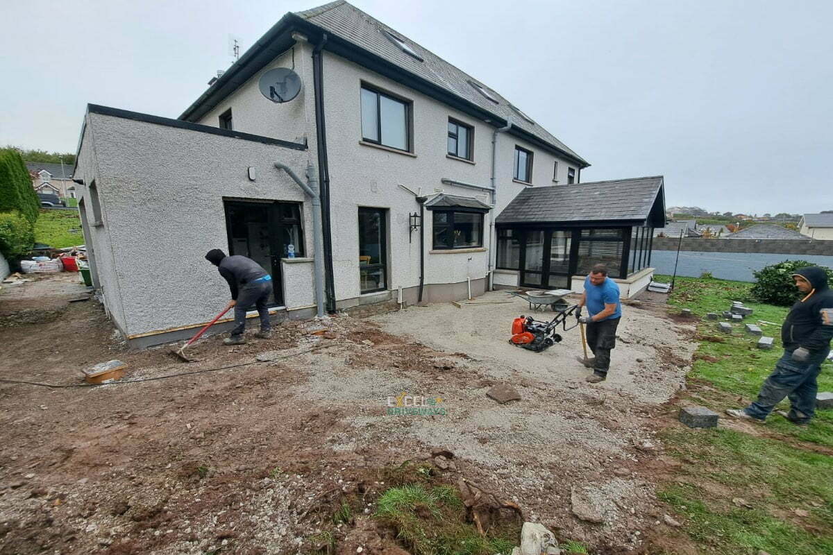 Patio with Silver Granite Slabs, Charcoal Border and Connemara Walling