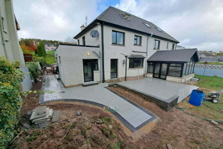 Patio with Silver Granite Slabs, Charcoal Border and Connemara Walling